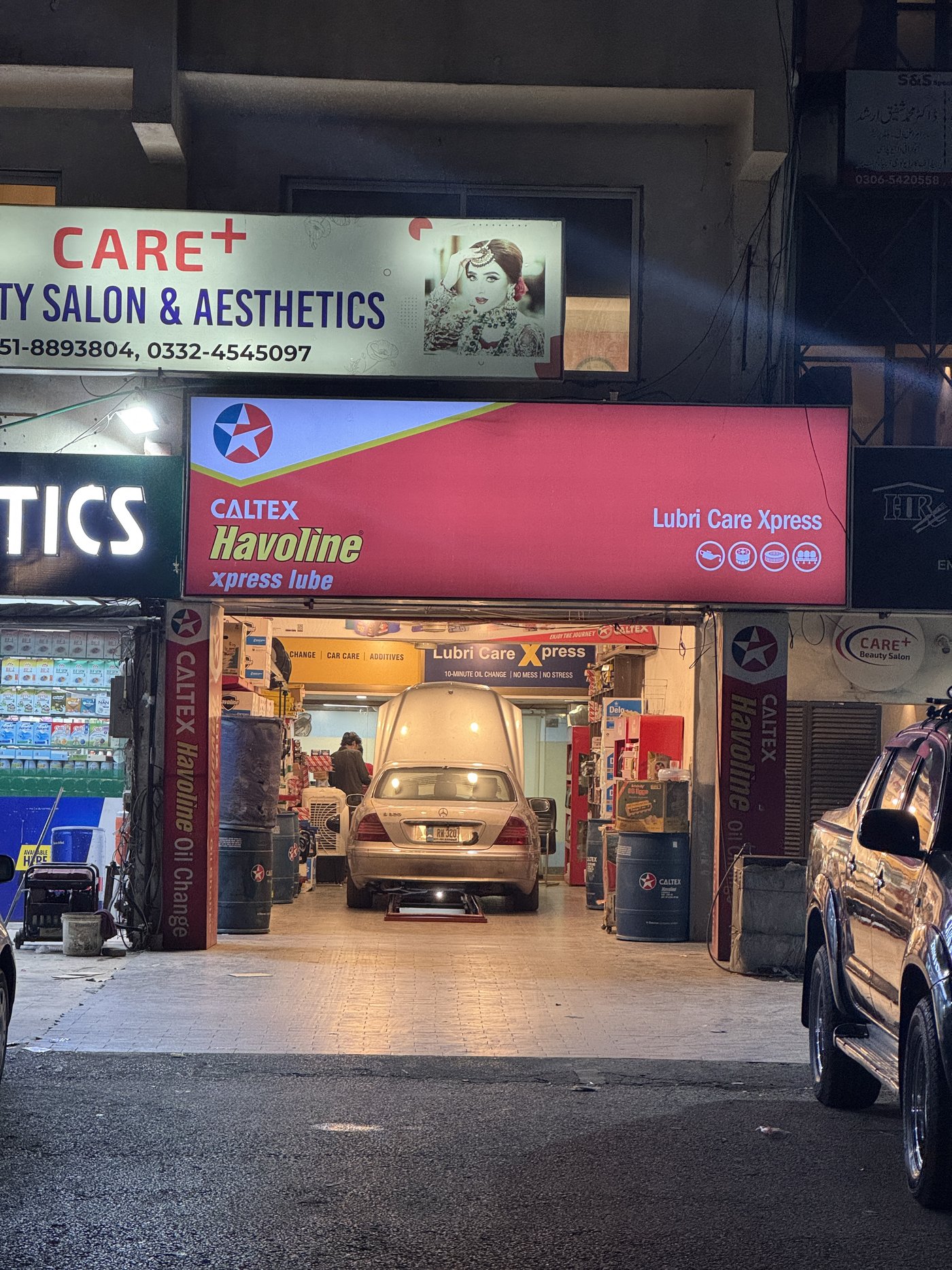 Lubri Care Xpress storefront lit up at night, G-8 Markaz, Islamabad
